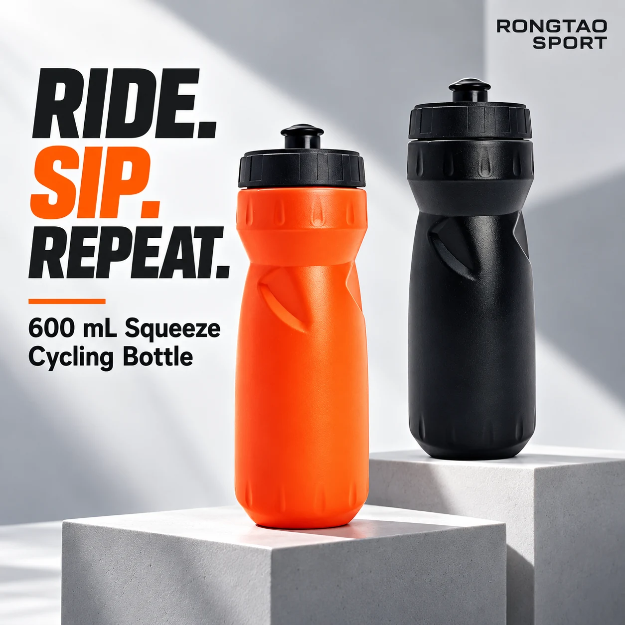 Orange and black 600 mL squeeze cycling bottles on studio display stands.